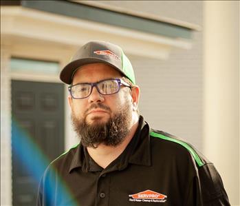 Man with dark beard and glasses 