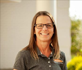 Woman in grey shirt and glasses 