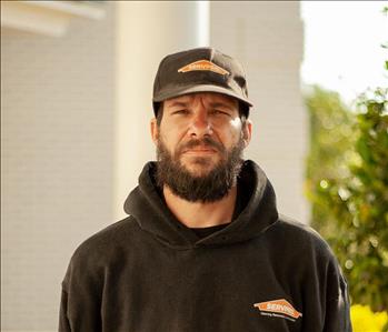 Man with beard in a black hat