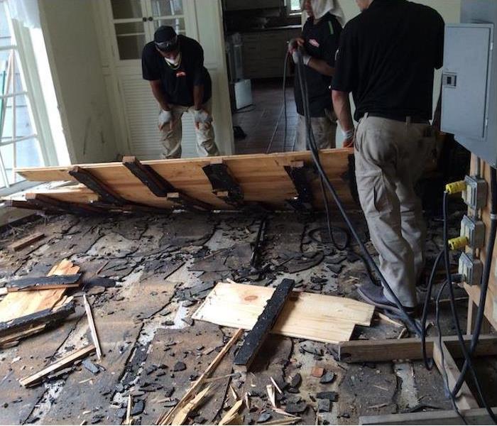 SERVPRO technicians removing flooring with fire damage