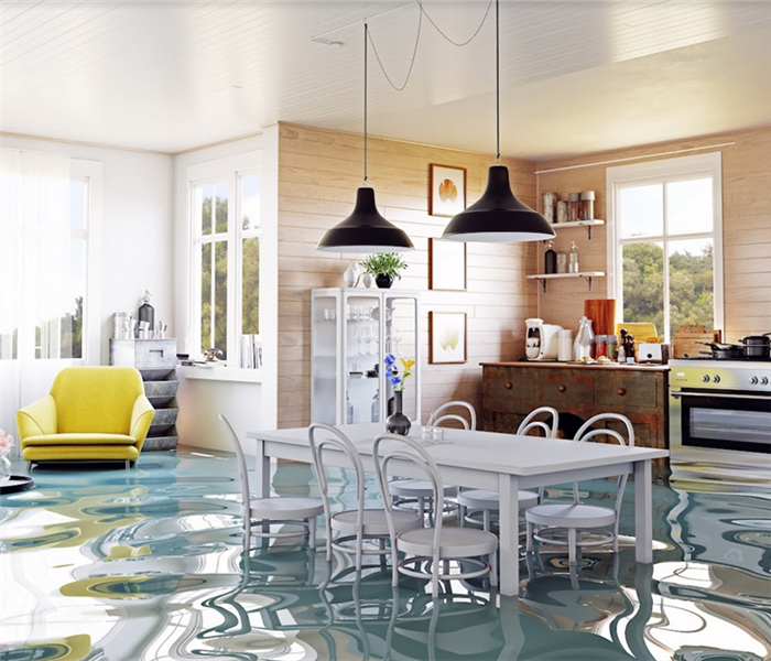 a flooded kitchen and dining room with water covering the floor