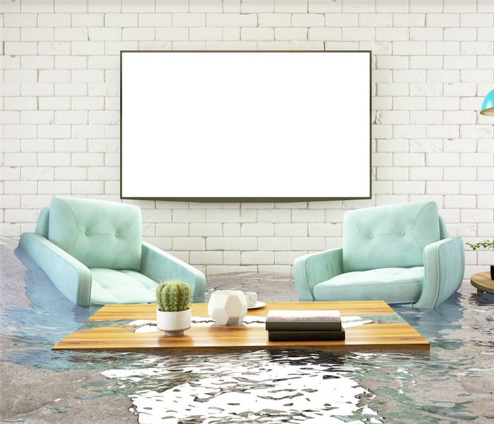 flooded room with green recliners and a coffee table